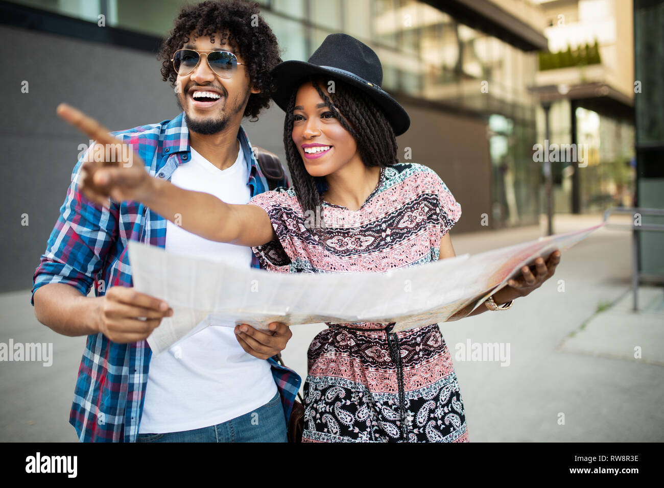 Happy black couple on vacation sightseeing city with map Stock Photo