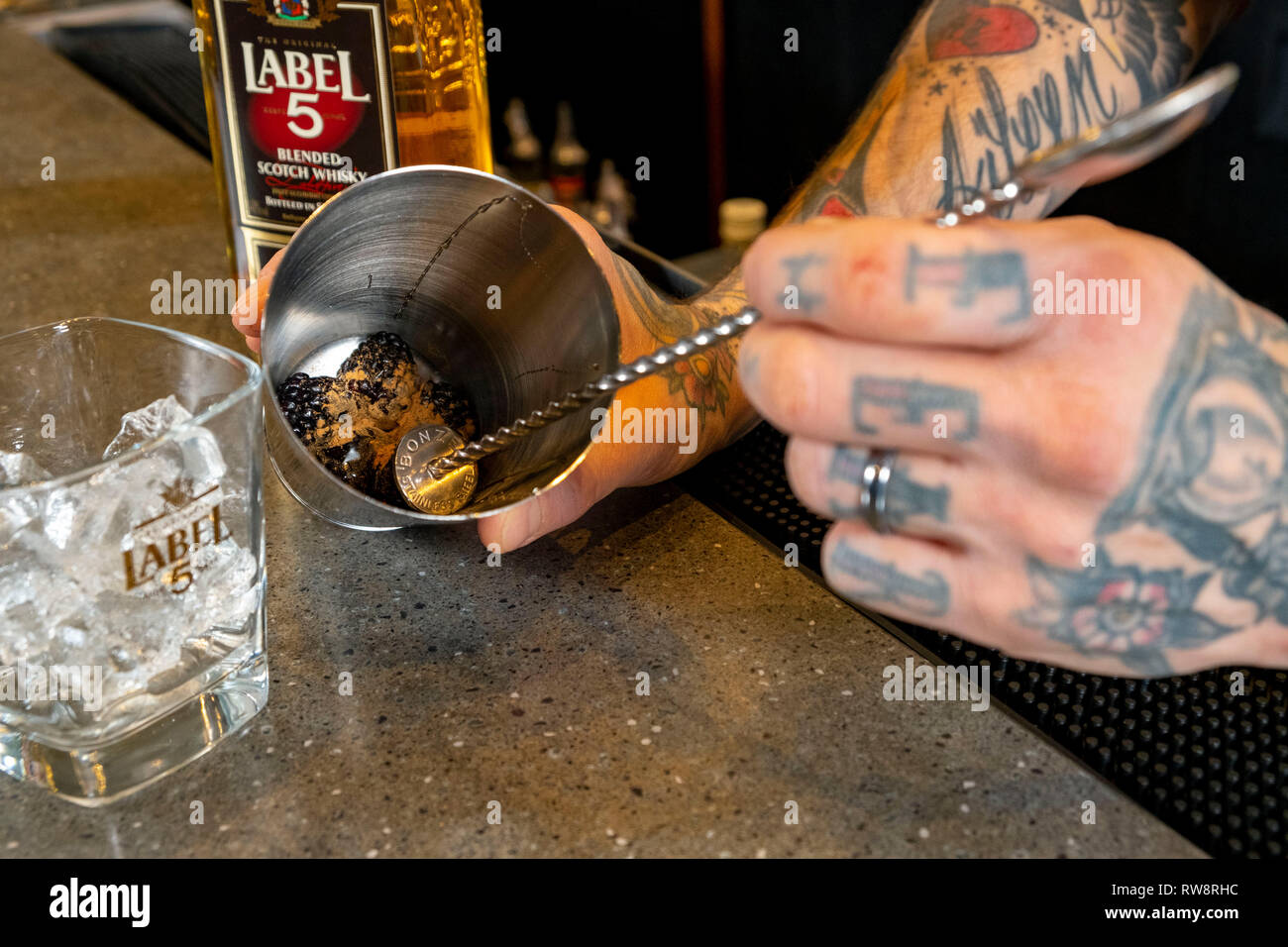 Whisky Cocktail being made by barman Stock Photo
