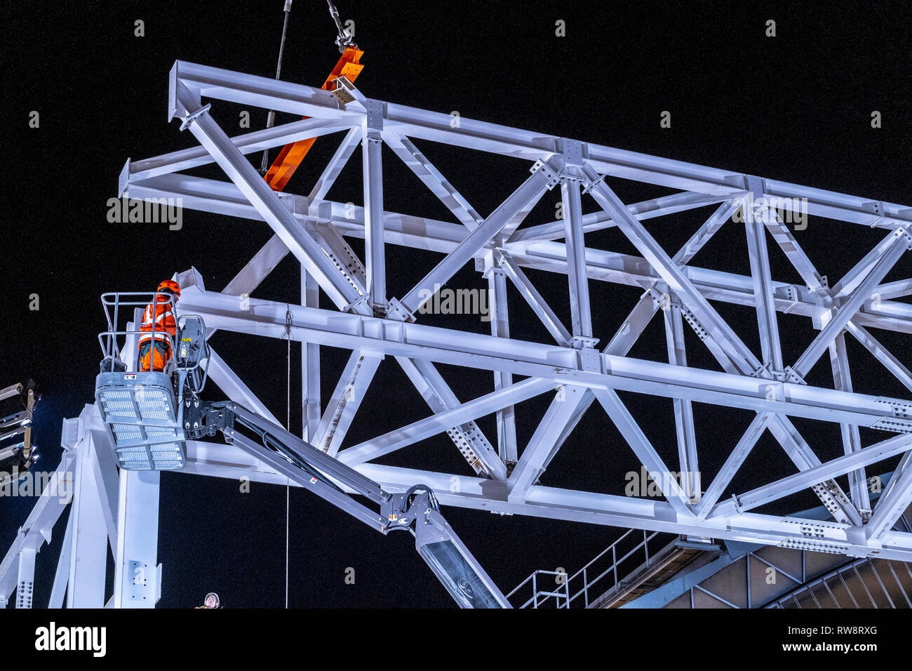 Evening crane lift of major steel work Stock Photo