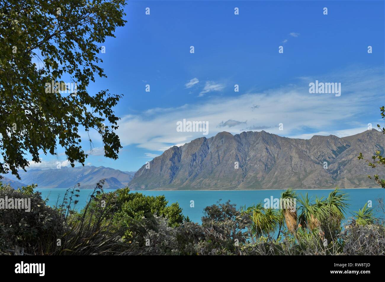 beautiful scenery at blue Lake Hawea with mountains near Wanaka, New Zealand Stock Photo