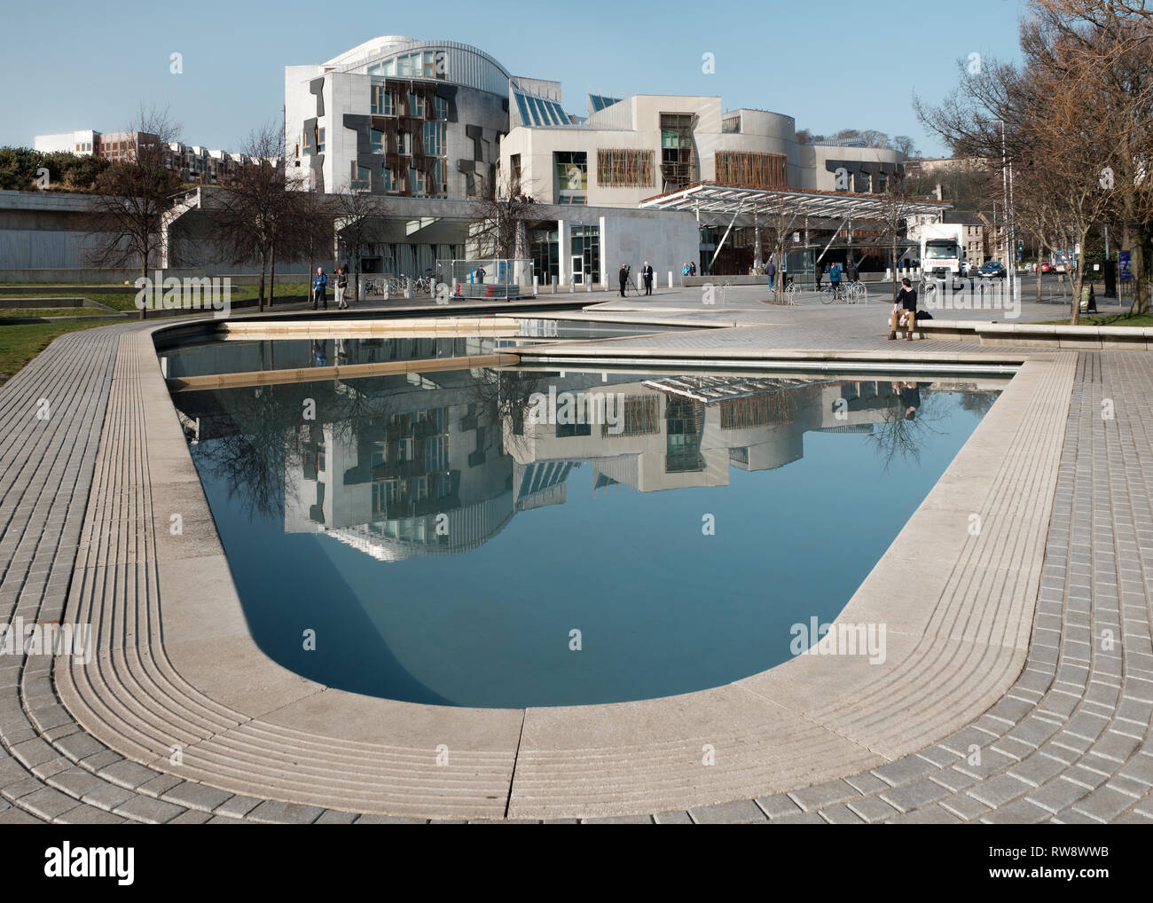 View across a lake outside the Scottish Parliament Building at Holyrood in Edinburgh on a cloudy day Stock Photo