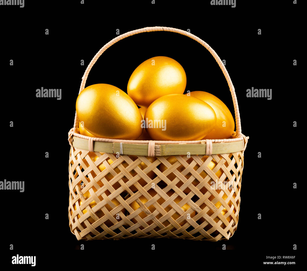 gold eggs in a basket on black background Stock Photo Alamy