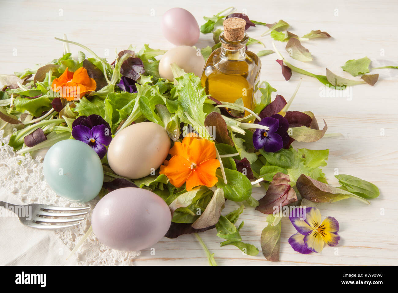 Lettuce and flower salad on woody white background spring, easter Stock Photo