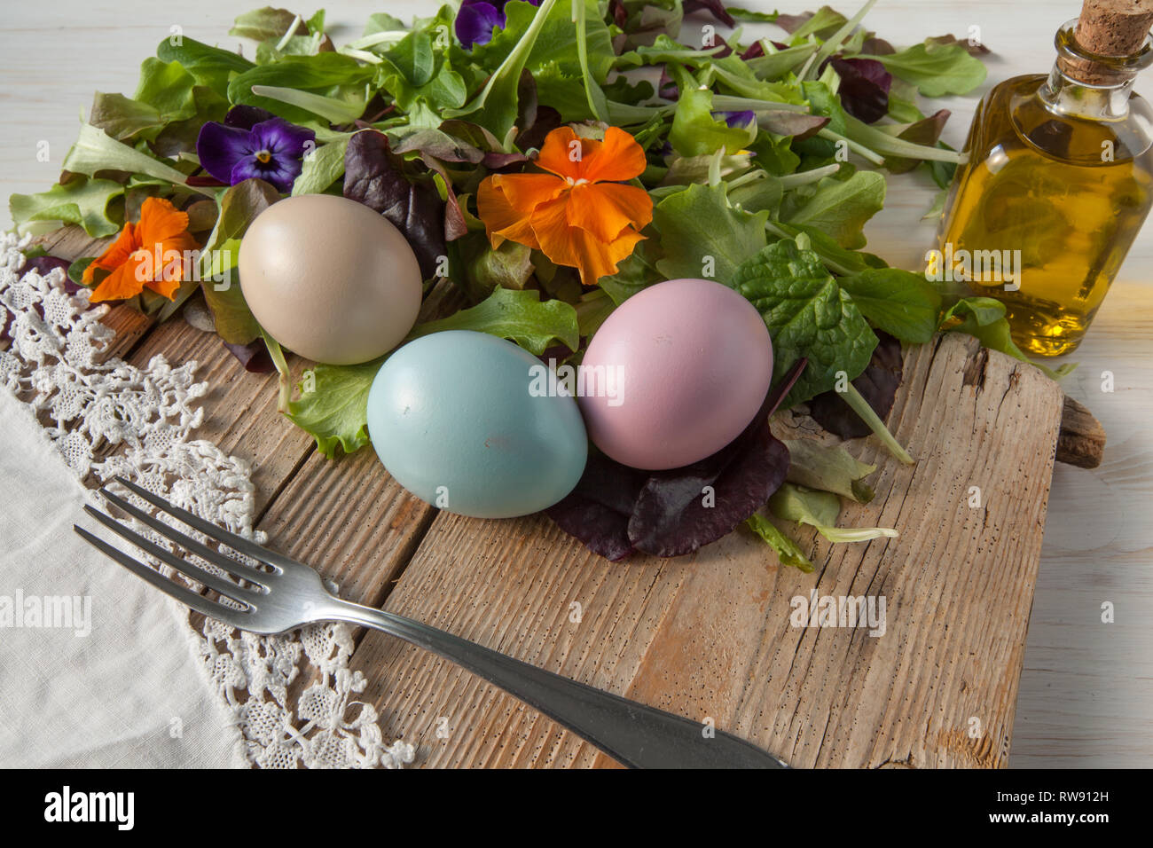 Lettuce and flower salad on woody white background spring, easter Stock Photo