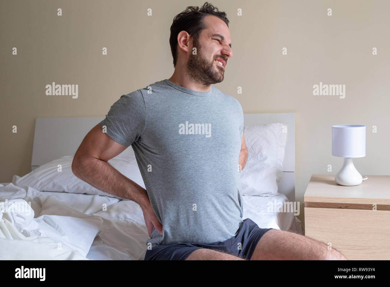 Man feeling backache after sleeping in bed Stock Photo Alamy