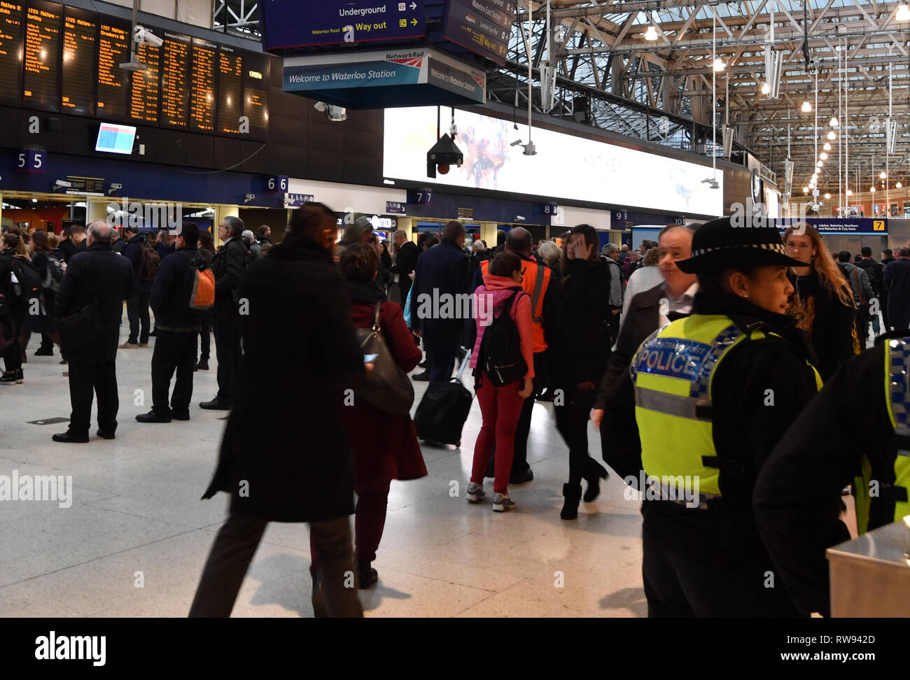 British transport Police Officers on the concourse of Waterloo Railway Station, London, after three small improvised explosive devices were found at buildings at Heathrow Airport, London City Airport and Waterloo in what the Metropolitan Police Counter Terrorism Command said was being treated as a 'linked series'. Stock Photo