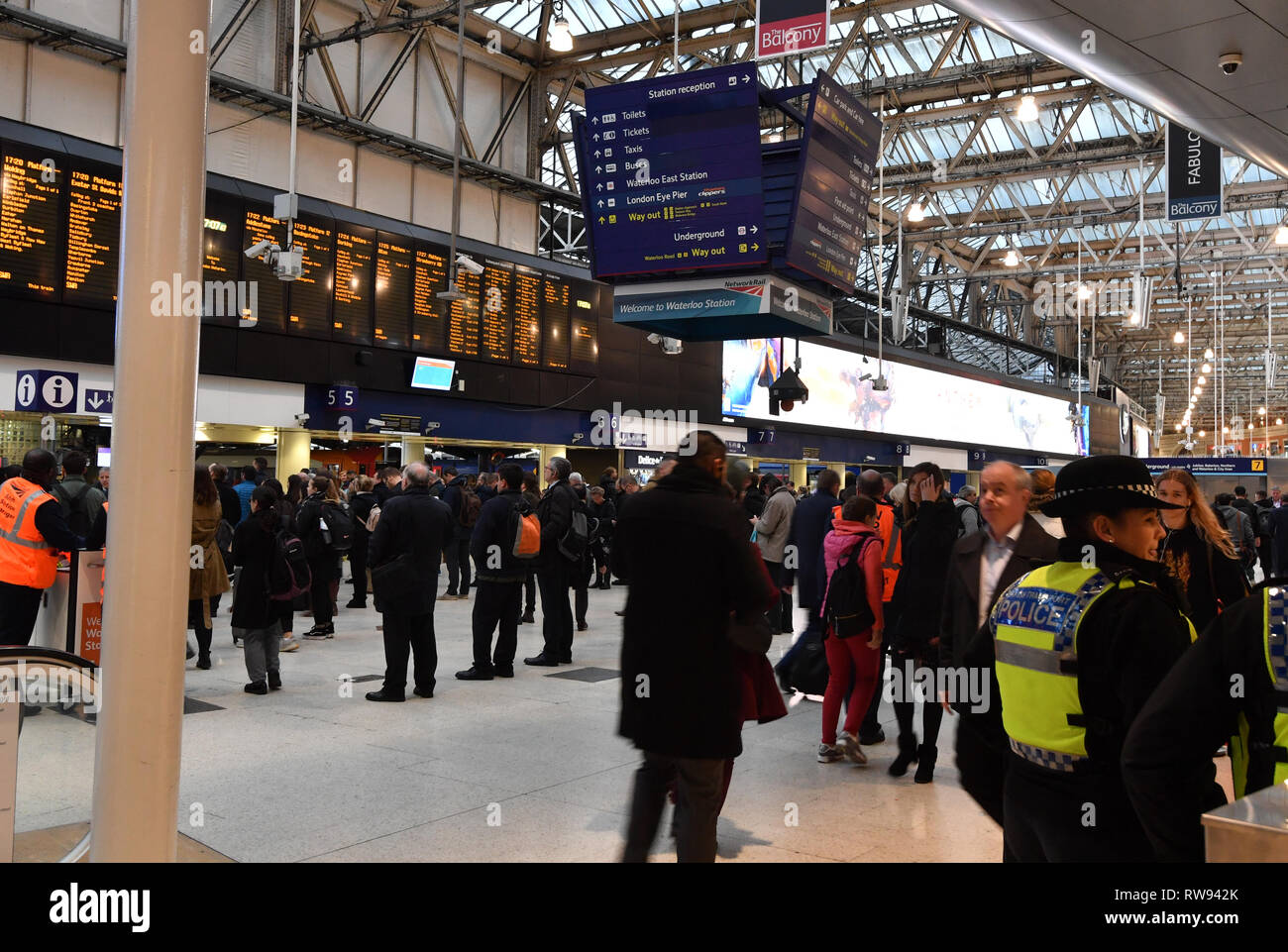 British Transport Police Officers on the concourse of Waterloo Railway Station, London, after three small improvised explosive devices were found at buildings at Heathrow Airport, London City Airport and Waterloo in what the Metropolitan Police Counter Terrorism Command said was being treated as a 'linked series'. Stock Photo