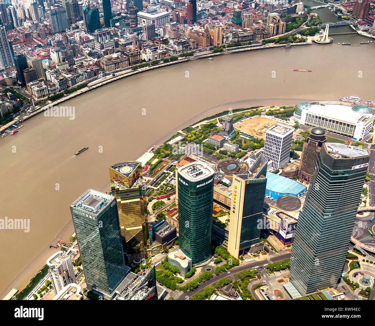 Looking down on skyscrapers in Pudong and across the Huangpu River to the colonial architecture of The Bund. Shanghai, China. Stock Photo