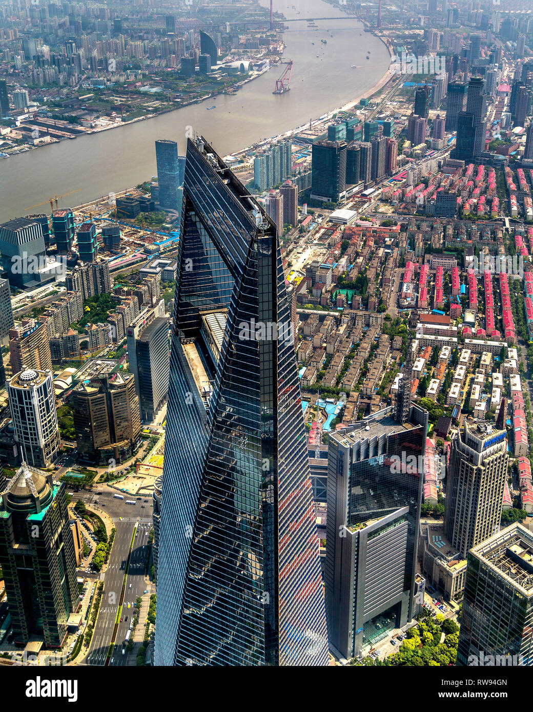 The Shanghai World Financial Center towers above Pudong. In the background a bend in the Huangpu River. Shanghai, China. Stock Photo
