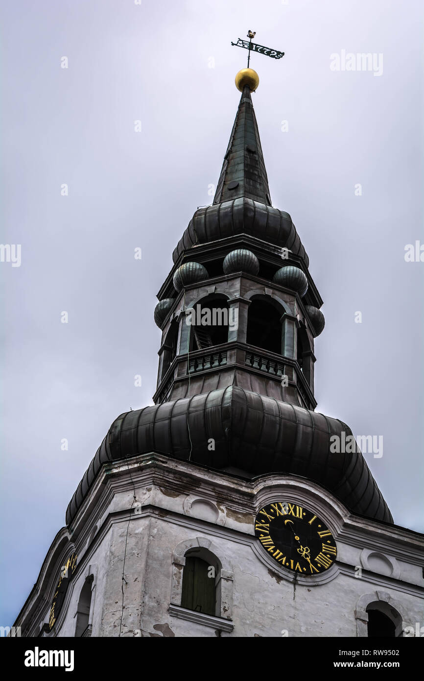 Baroque bell tower of lutheran St. Mary's Cathedral, also known as Dome Church, against grey cloudy sky in Tallinn, Estonia. Oldest church in Tallinn  Stock Photo