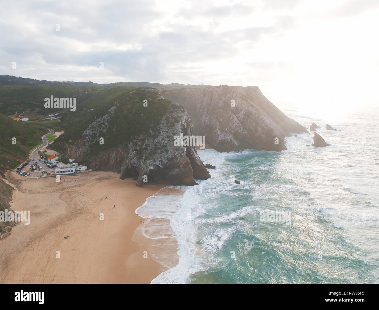 Aerial view from a sandy beach at the sunset with an amazing cliff ...