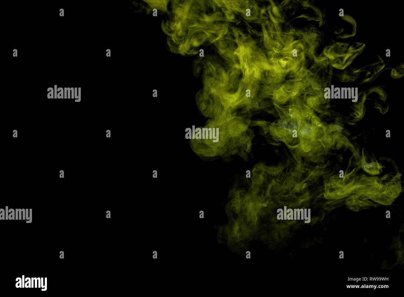 Abstract art blue and green colored smoke on black isolated background. Stop the movement of multicolored smoke on dark background Stock Photo