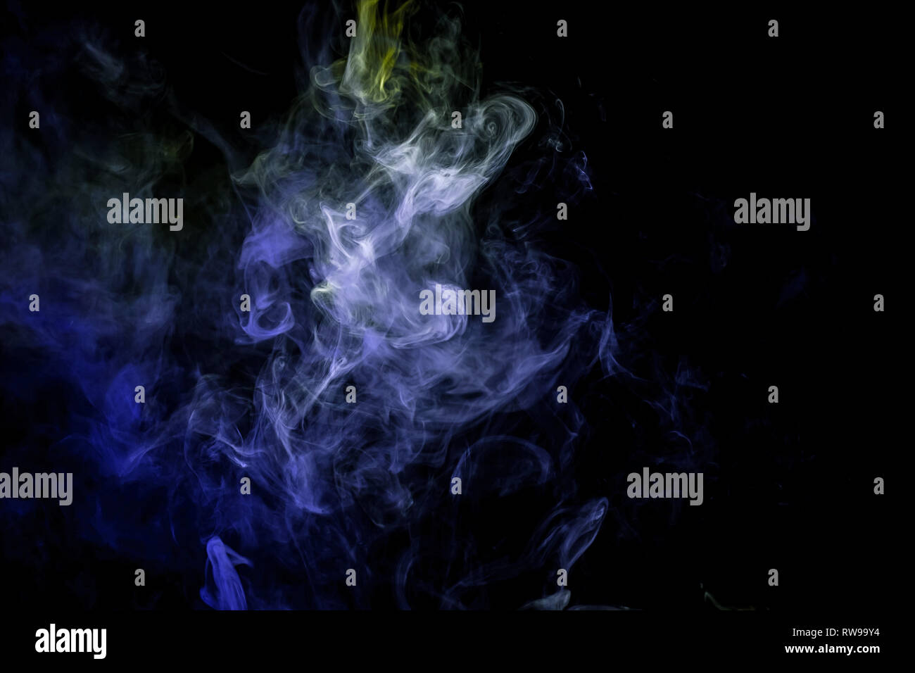 Close up swirling  green and blue smoke on black isolated background Stock Photo