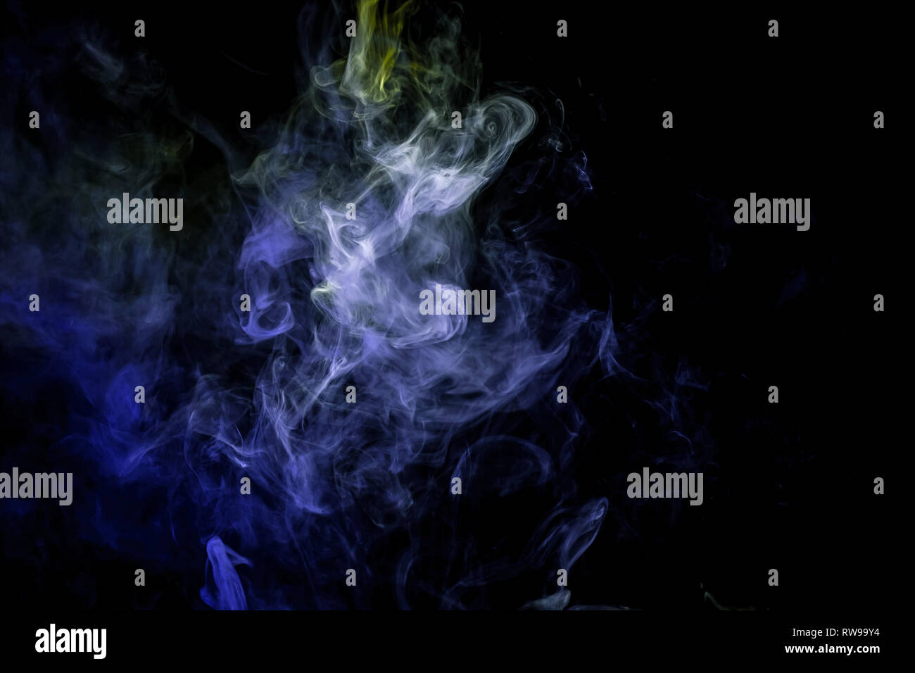 Close up swirling green and blue smoke on black isolated background ...