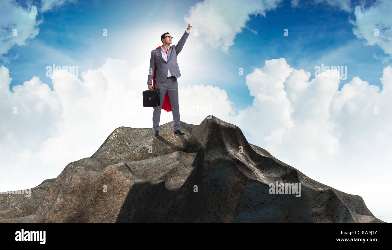 Superhero businessman on top of mountain Stock Photo - Alamy