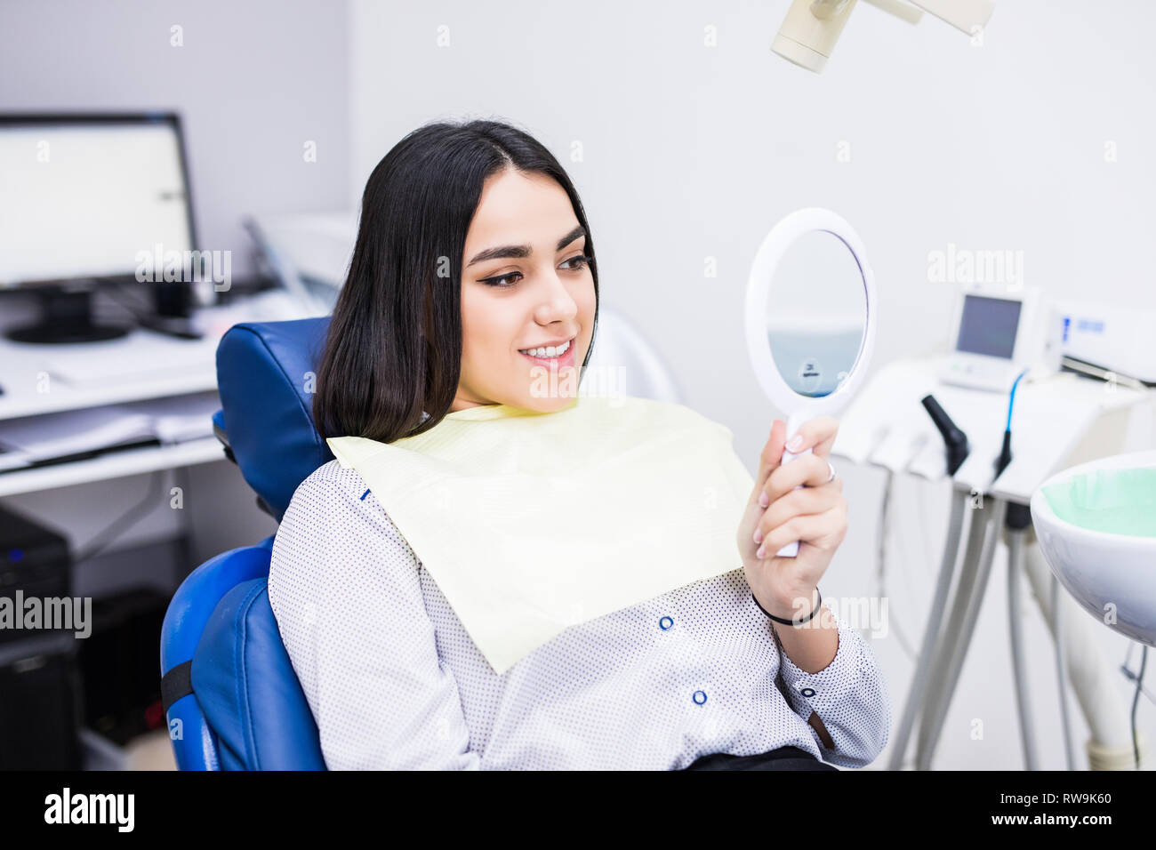 The girl smiles in dentistry. patient dentist racing model at the