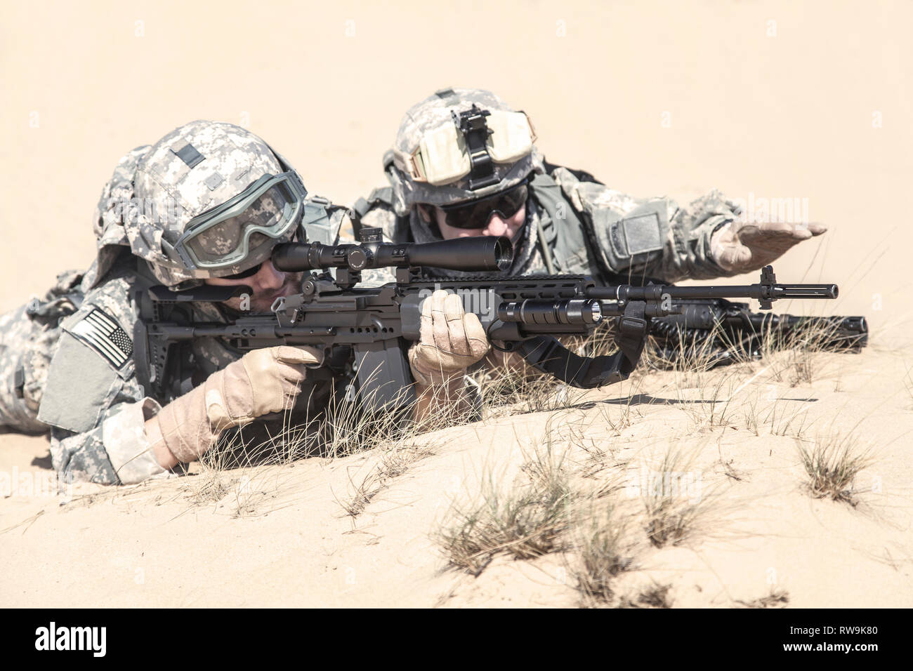 U.S. airborne infantry spotter and marksman in action in the desert. Stock Photo