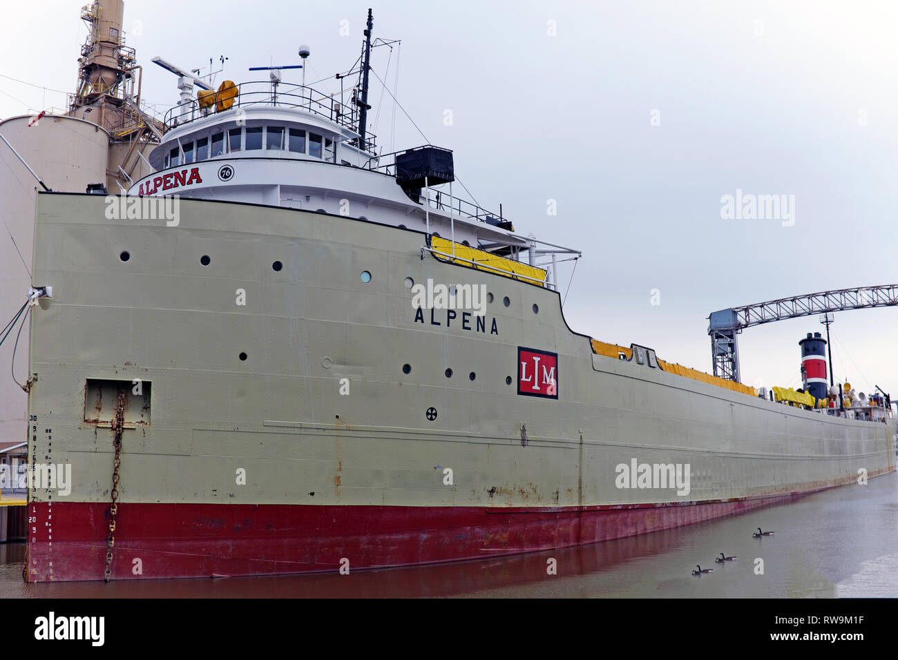 The Alpena Ship, an old and active Great Lakes freighter carrying cement, is docked on the Cuyahoga River in Cleveland, Ohio, USA Stock Photo