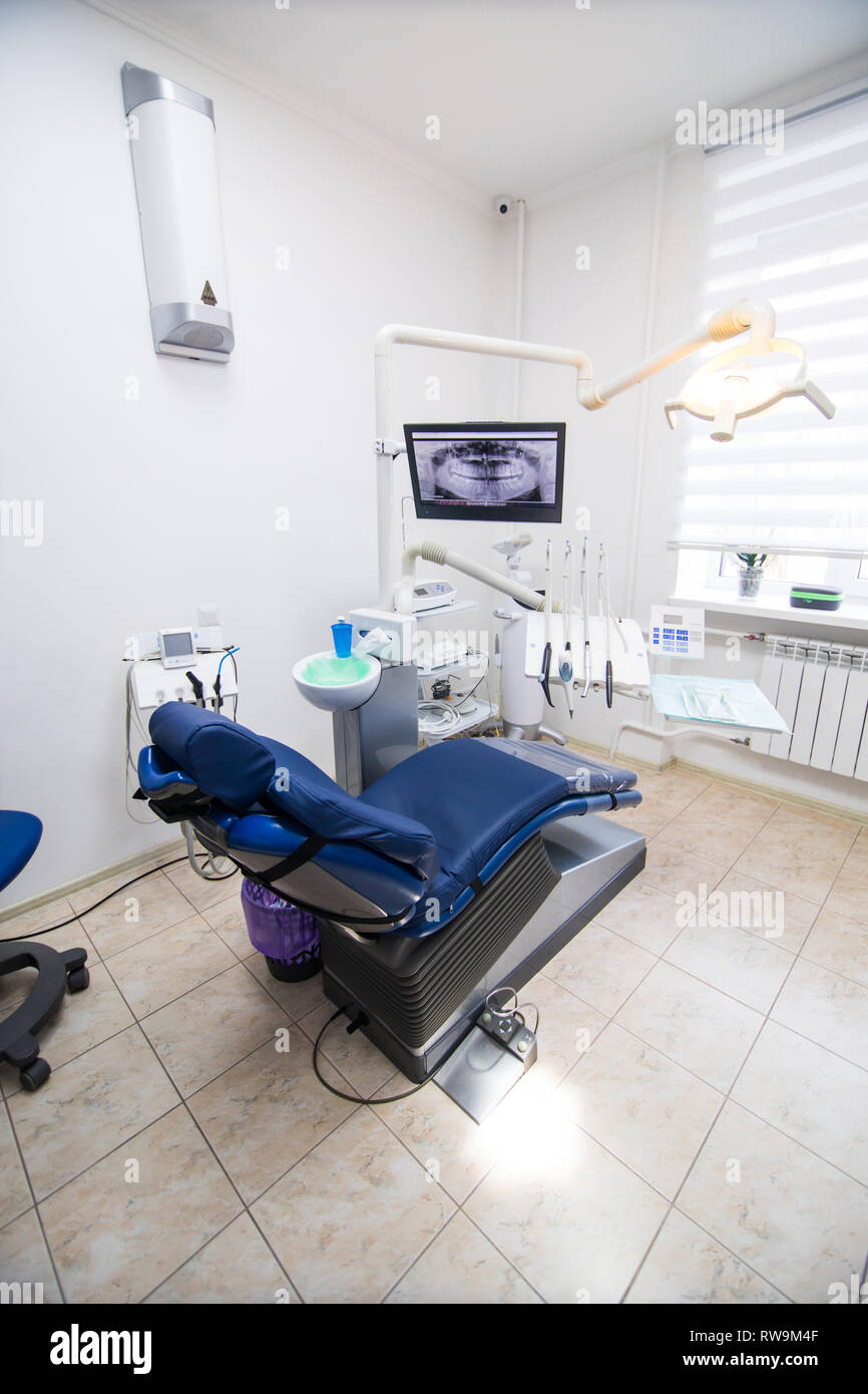 Modern Dental Practice Dental Chair And Other Accessories Used By Dentists In Blue Stock Photo Alamy