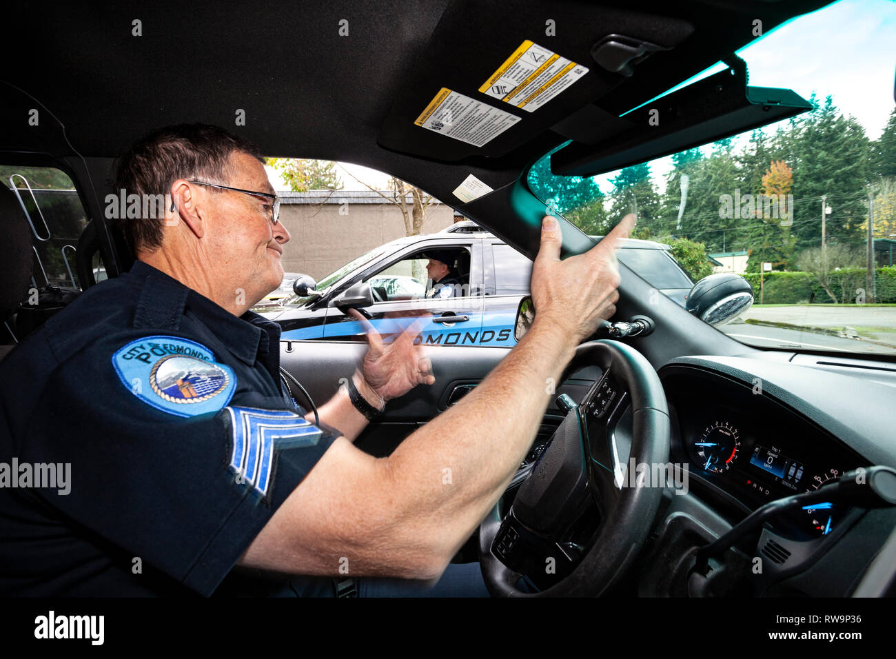 PE00381-00...WASHINGTON - Sergeant Robert Barker of the Edmonds Police Department talks with another officer during patrol. Stock Photo