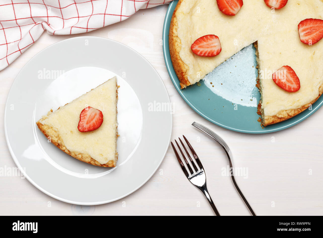 Classic cheesecake with strawberries on a white background. A piece on