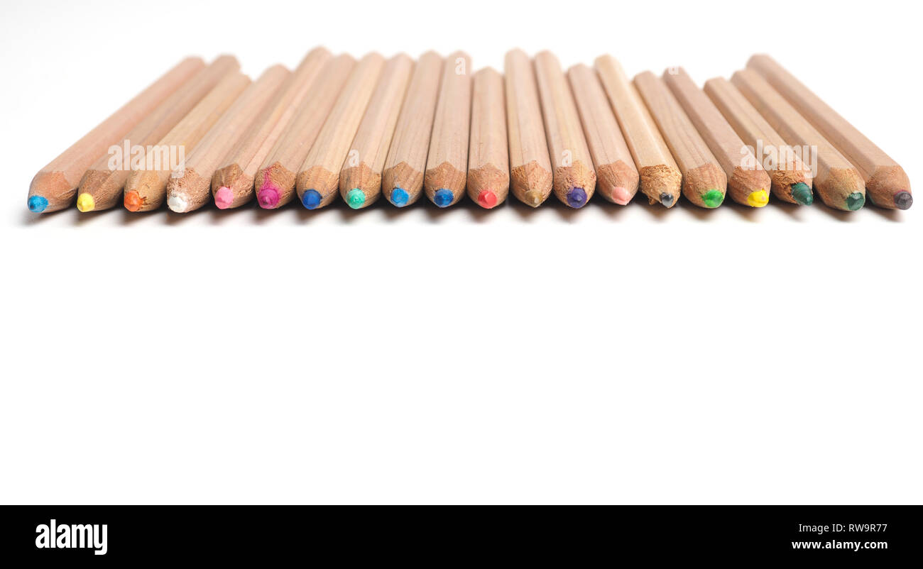Set of Artist pencils in a row on a white table with space for text, pamoramic image Stock Photo