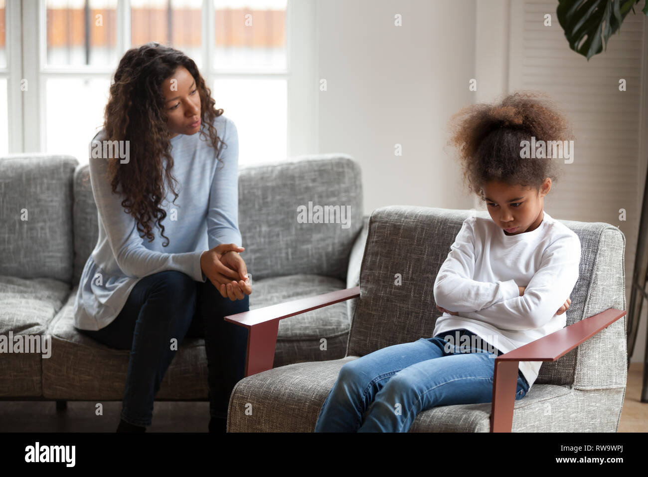 Sad African American girl avoid talking to mom Stock Photo