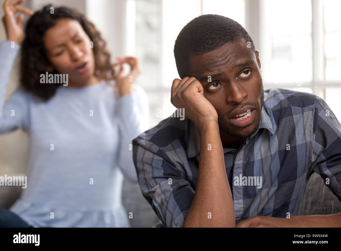 Frustrated black boyfriend tired of girlfriend lecturing Stock Photo