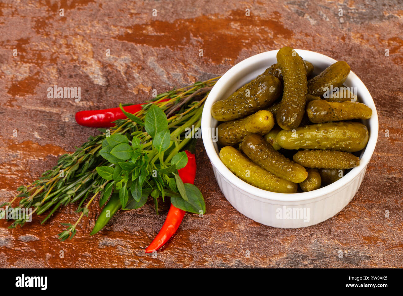 Pickled small cucumbers in the bowl served herbs Stock Photo Alamy