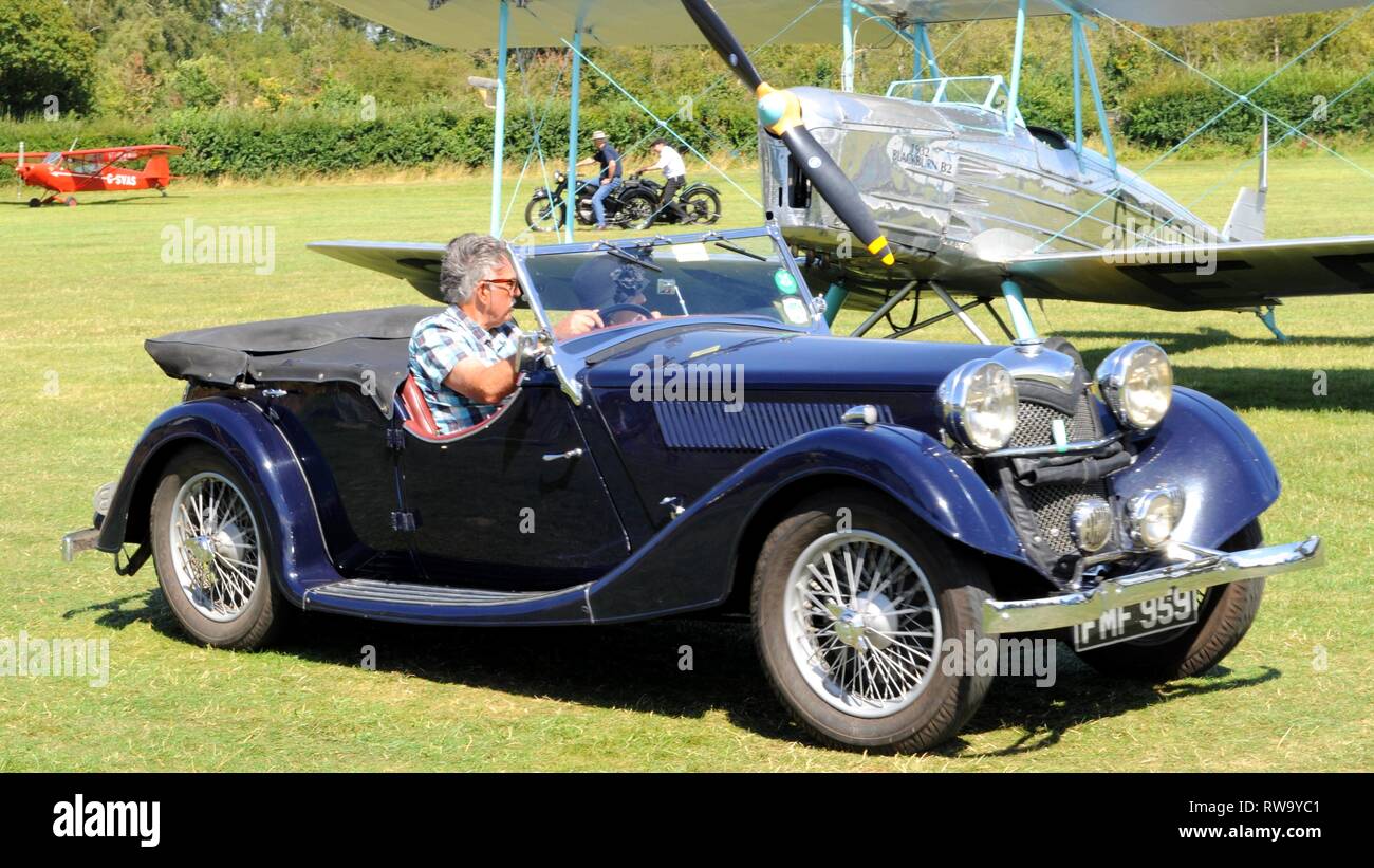 1937 Riley Lynx at the Shuttleworth Collection, UK, with Blackburn B2 in the background. Stock Photo