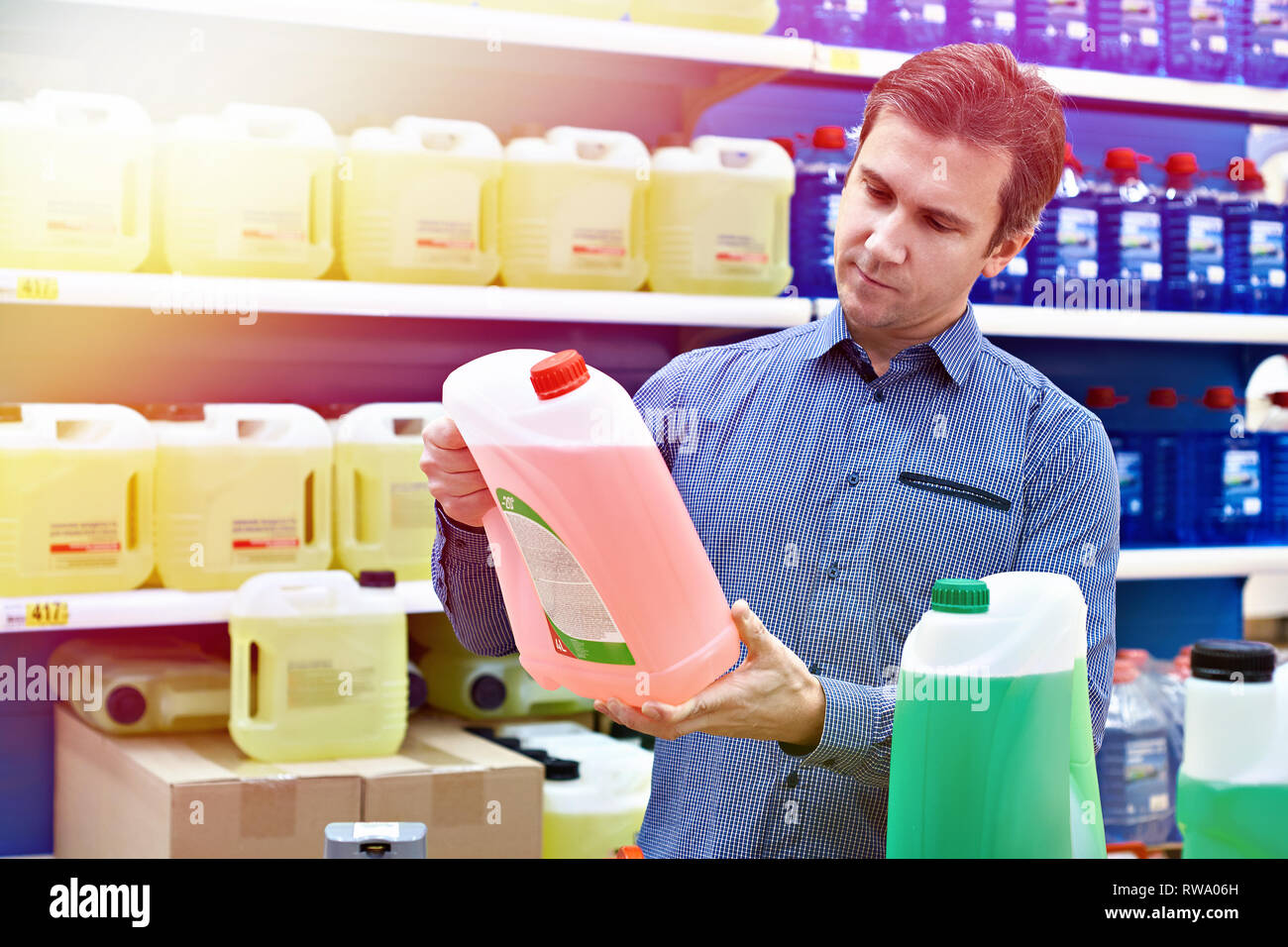 Man buys windshield washer fluid in the supermarket Stock Photo