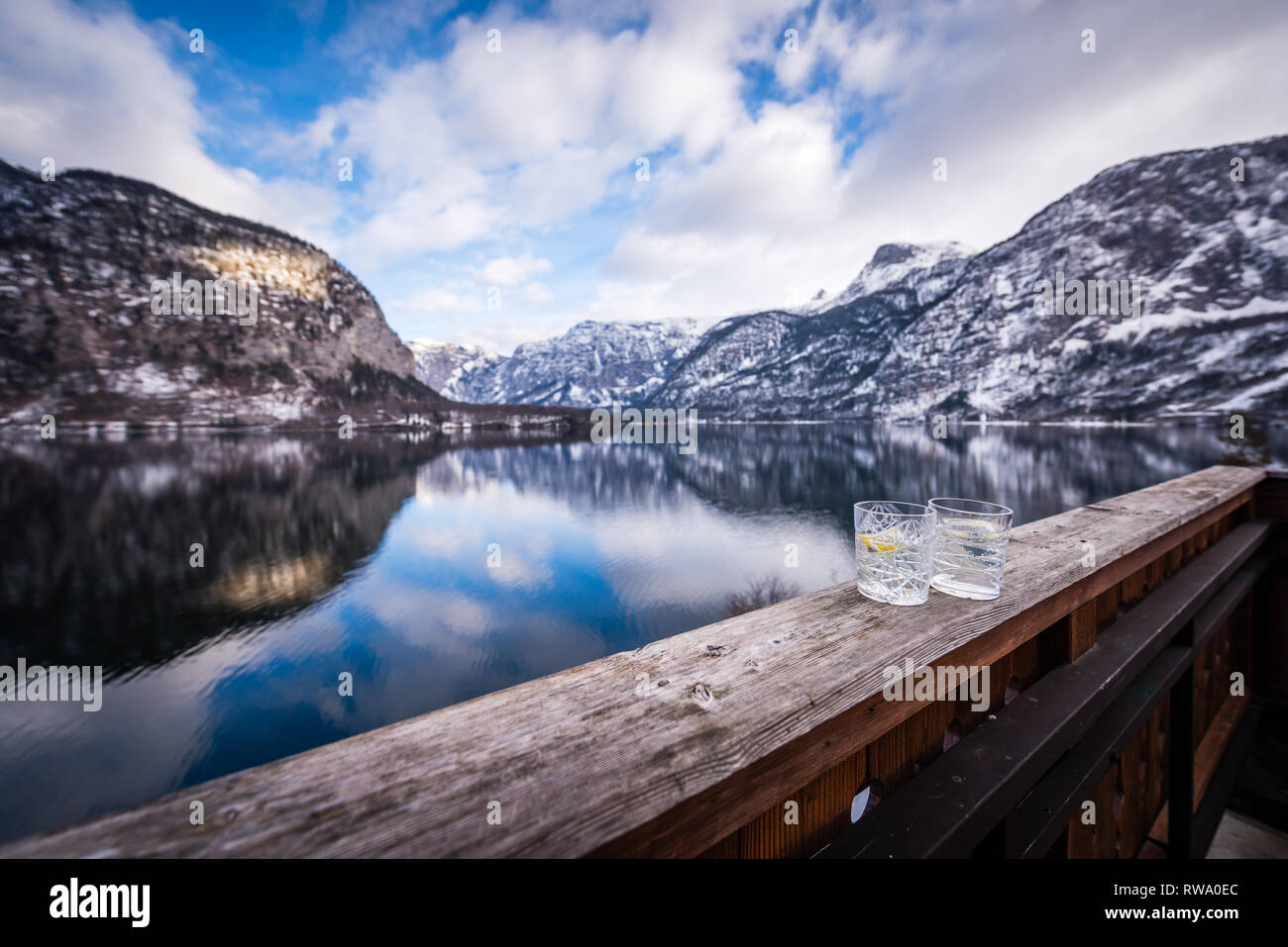 A lovely Gin & Tonic over the stunning views of Hallstatt Lake in the Salzkammergut, Austrian Lake Region Stock Photo