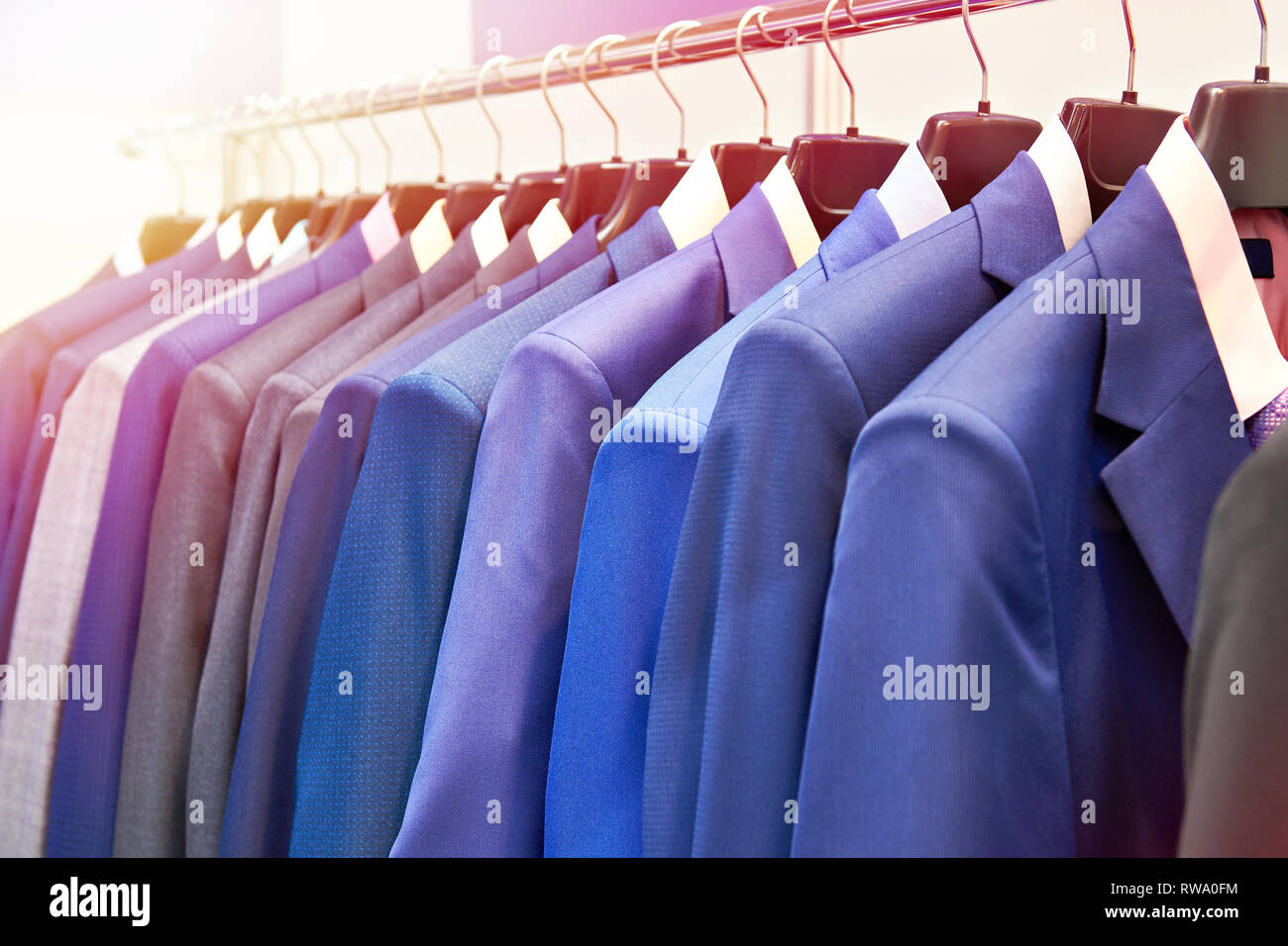 Men's suits with shirts in the clothing store Stock Photo
