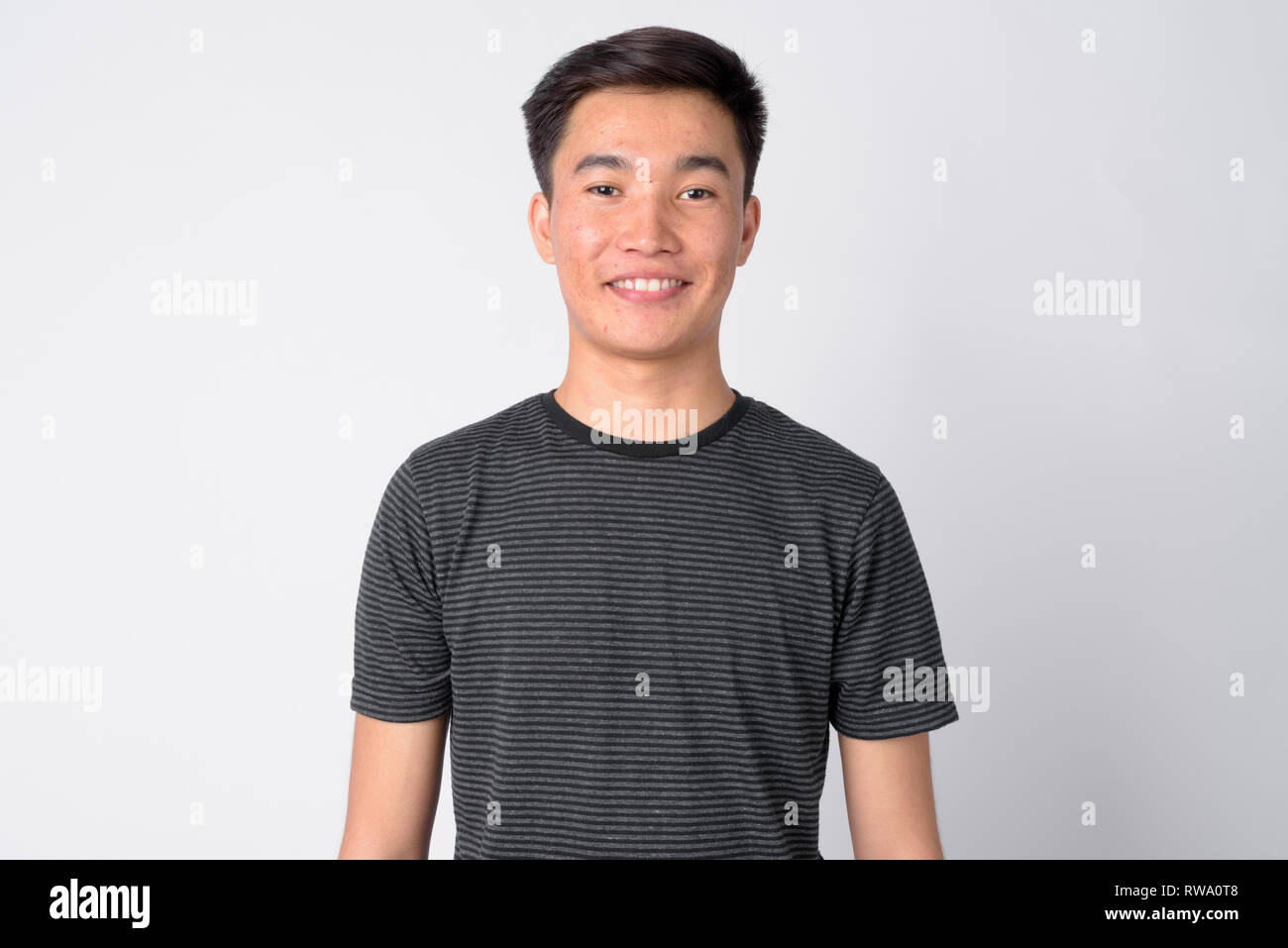 Face of young happy Asian man smiling against white background Stock ...