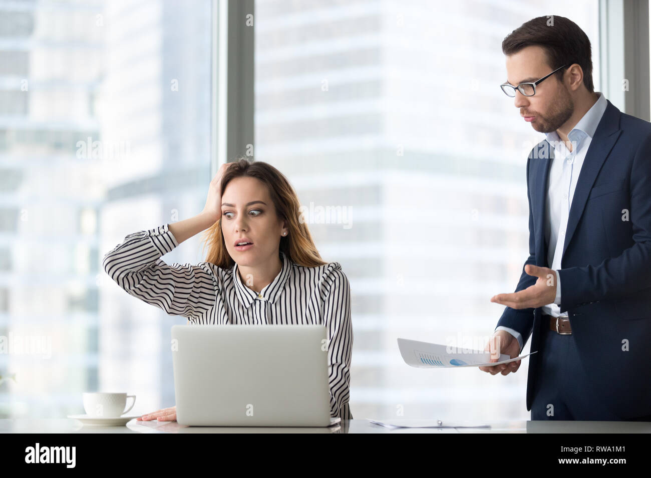 Angry boss scolding stressed lazy worker forgot missed deadline Stock Photo