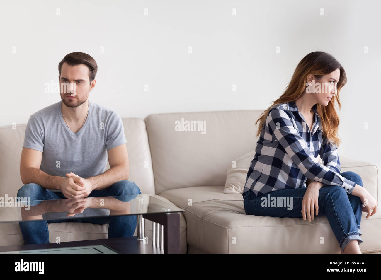 Unhappy stubborn married couple feel angry frustrated sitting on couch Stock Photo