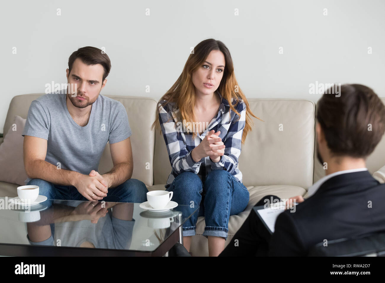 Unhappy married couple counseling, woman talking to psychologist Stock Photo