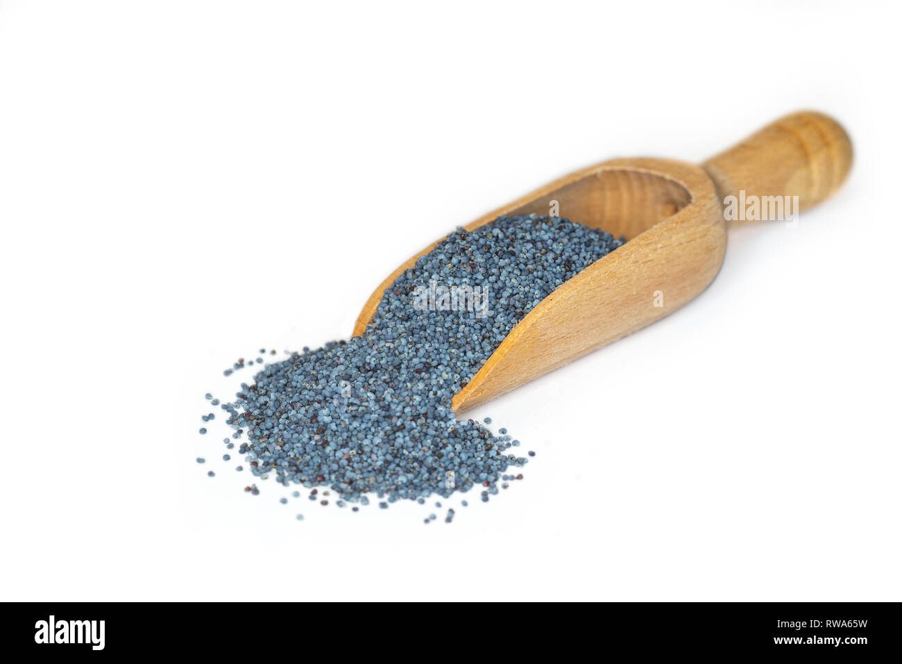 Closeup of blue poppy seeds, a plant based source of calcium, presented on a small wooden scoop Stock Photo