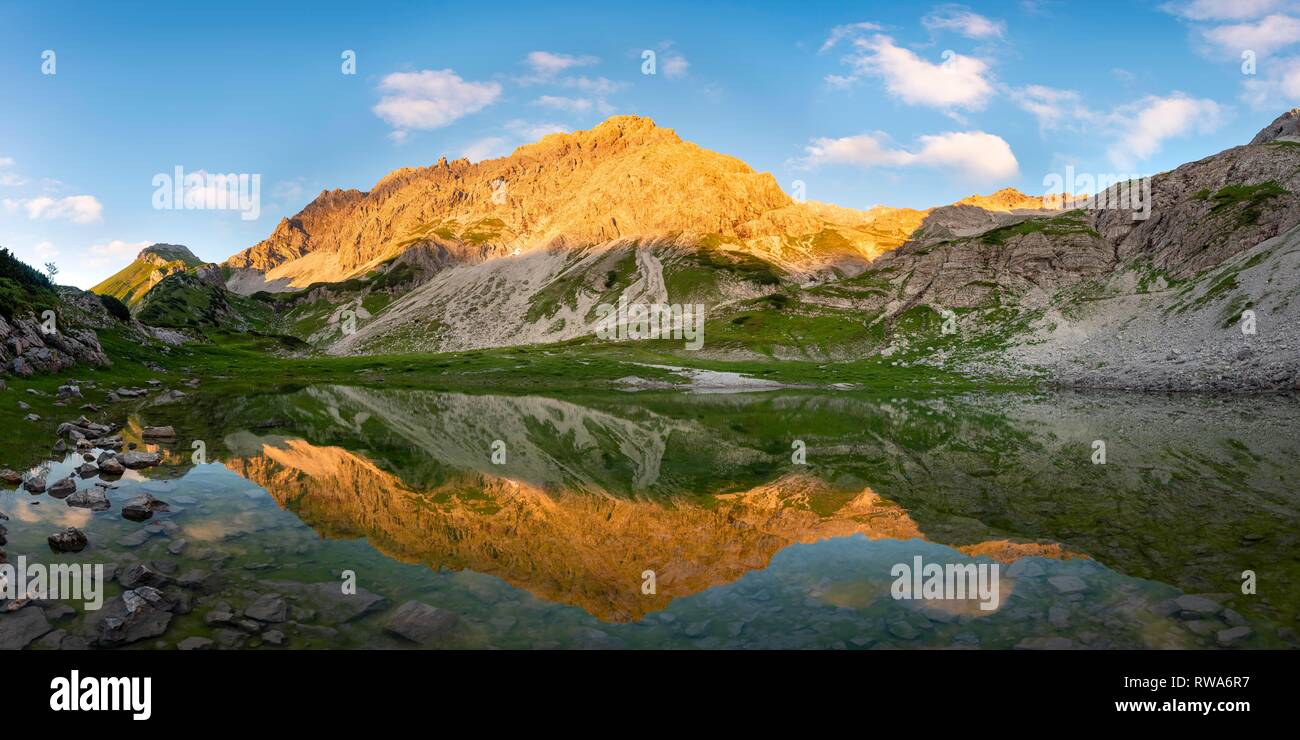 Mountains shine in the evening sun, Glasfelderkopf in the middle, Fuchskarspitze on the right, reflection in the mountain lake Stock Photo