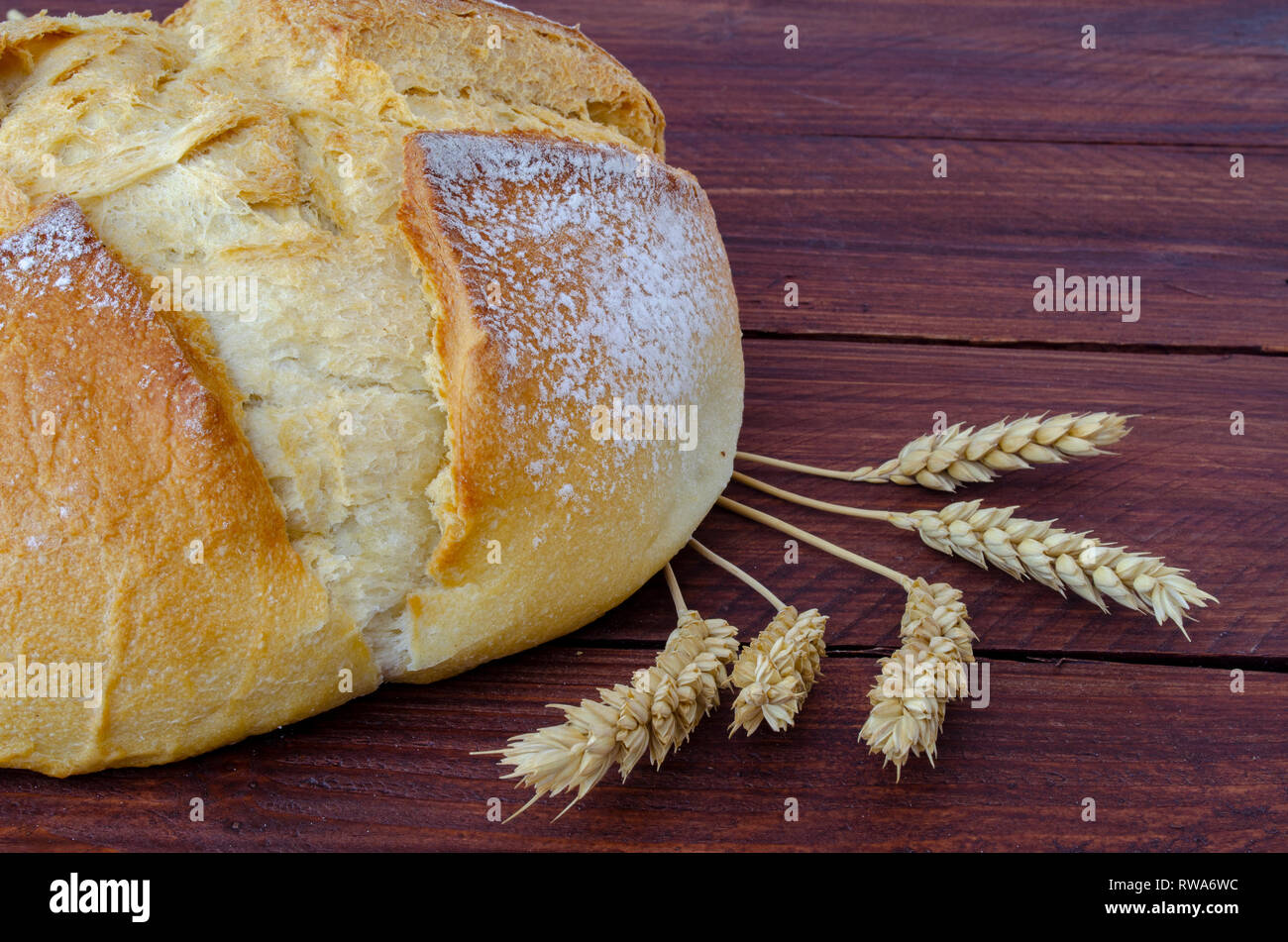 Freshly rustic loaf of bread isolated on wooden table background Stock ...