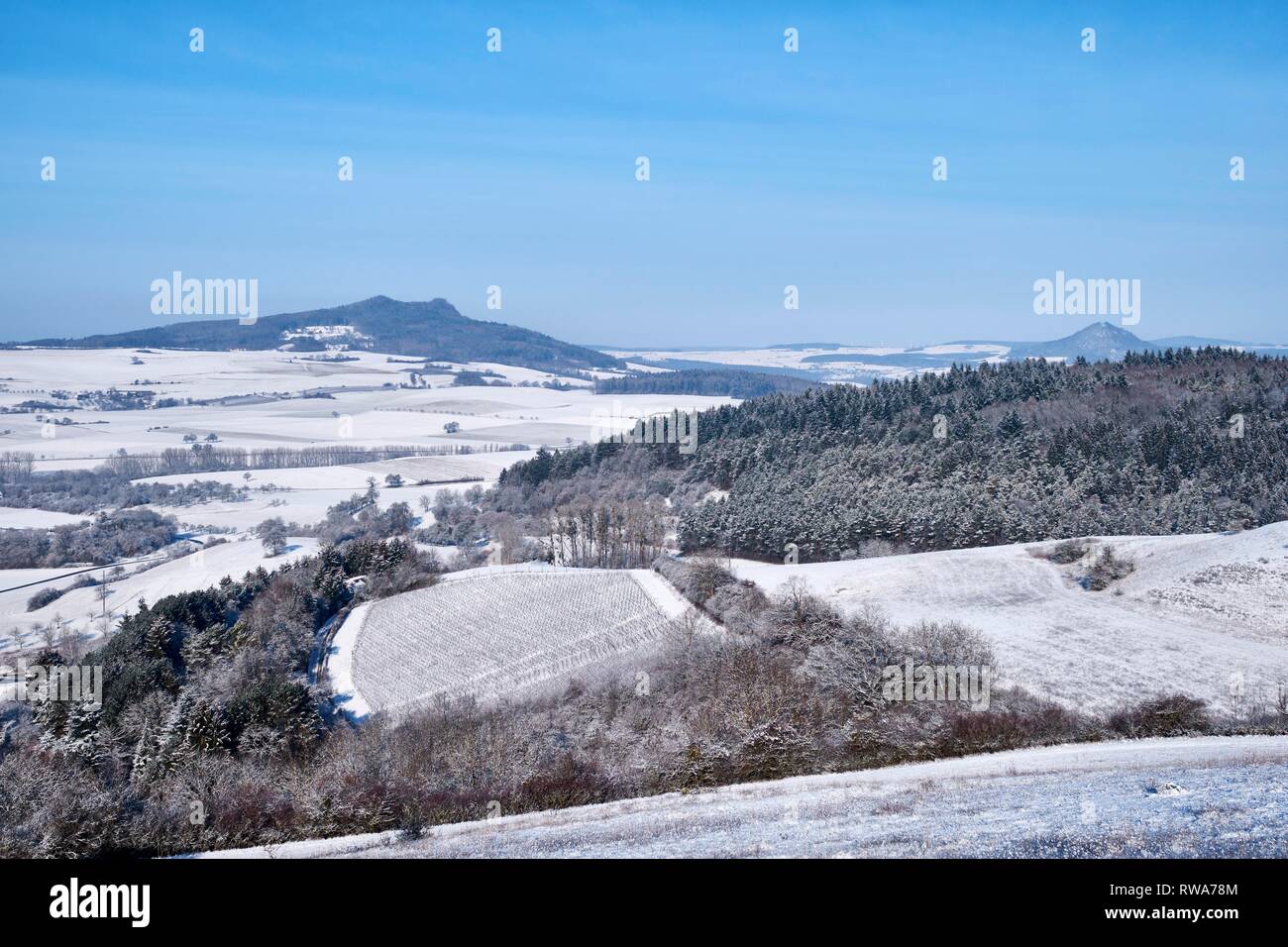 View into the Hegaul landscape, in winter, at the horizon of the Hohenstoffeln and Hohenhewen, Baden-Württemberg, Germany Stock Photo