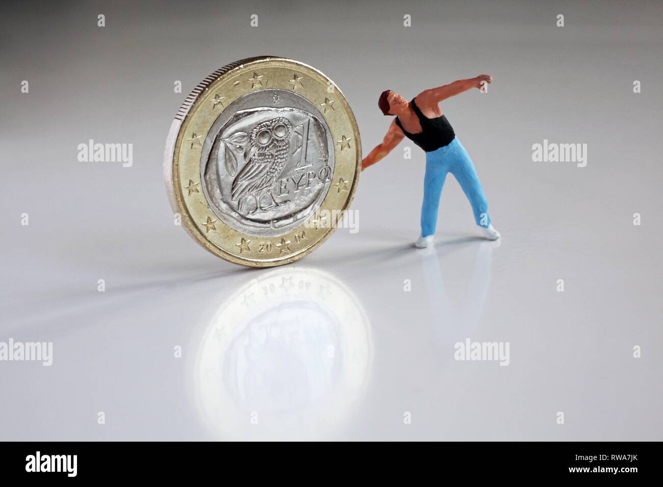 Discus thrower with Greek euro coin, Greece leaves the euro zone, Germany Stock Photo