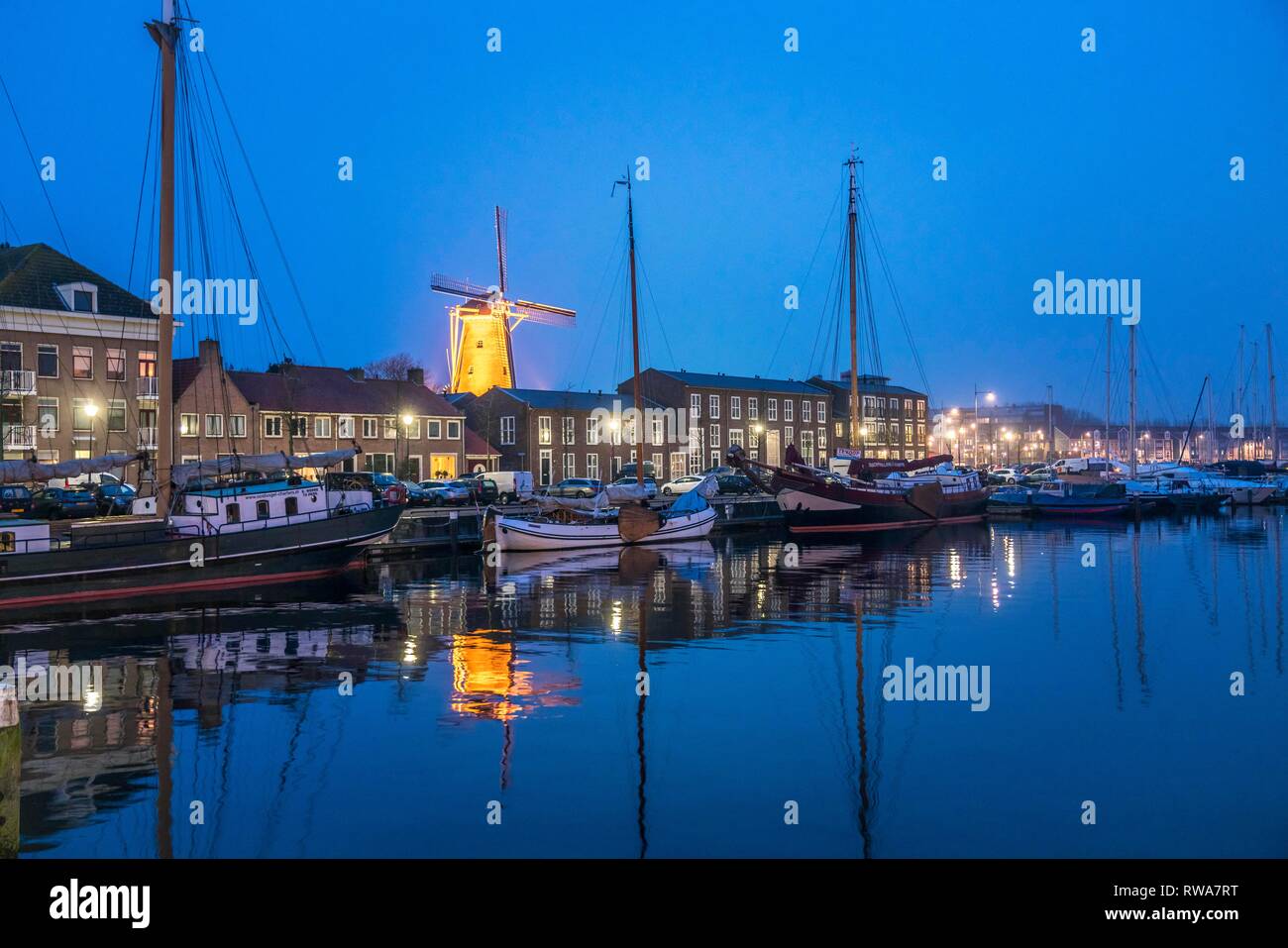 City view with harbour and windmill De Hoop at dusk, Hellevoetsluis, South Holland, Netherlands Stock Photo