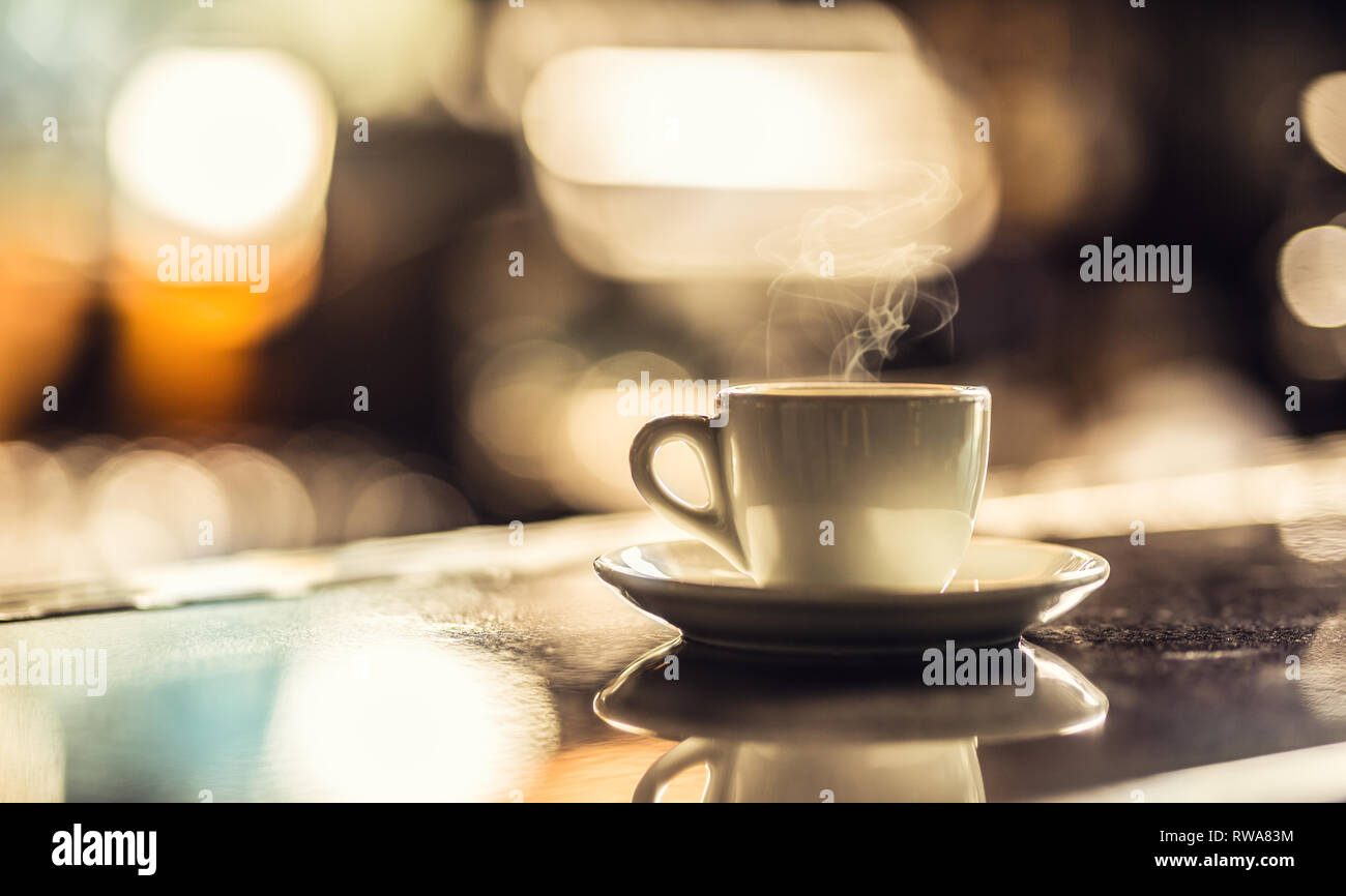 Cup of coffee on bar desk in night club. Stock Photo