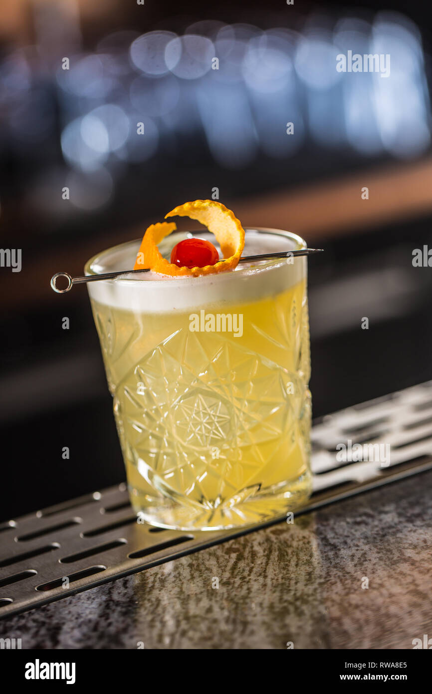 Cocktail drink whiskey sour at barcounter in night club or restaurant. Stock Photo