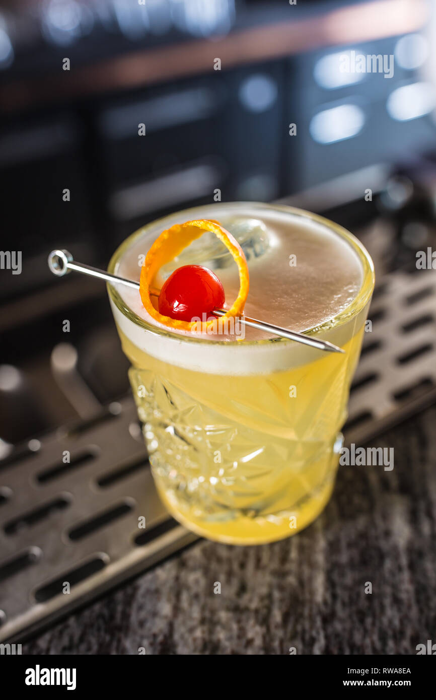 Cocktail drink whiskey sour at barcounter in night club or restaurant. Stock Photo
