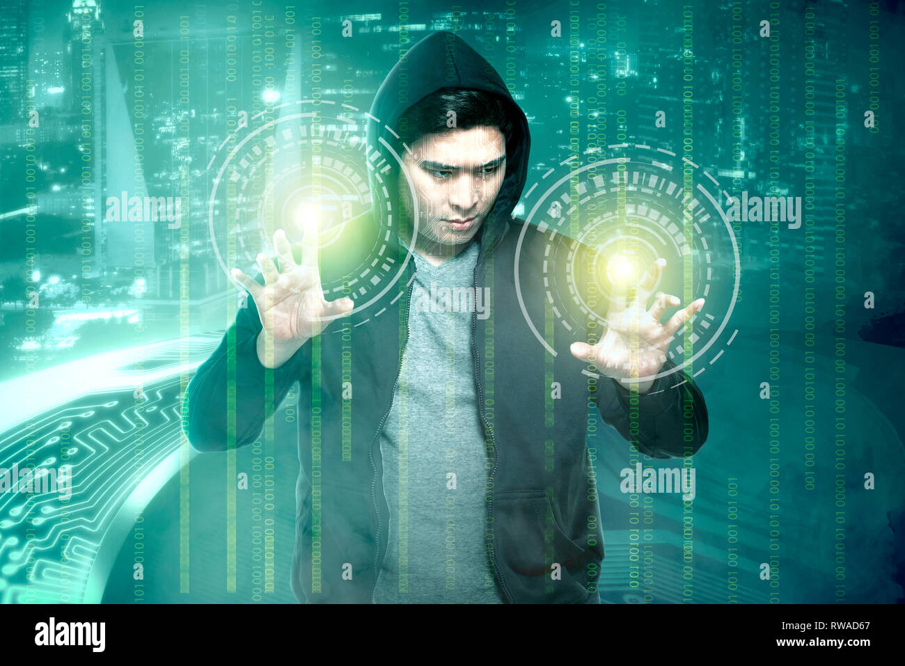 Young asian hacker in black hoodie touching virtual screen with binary code over digital background Stock Photo