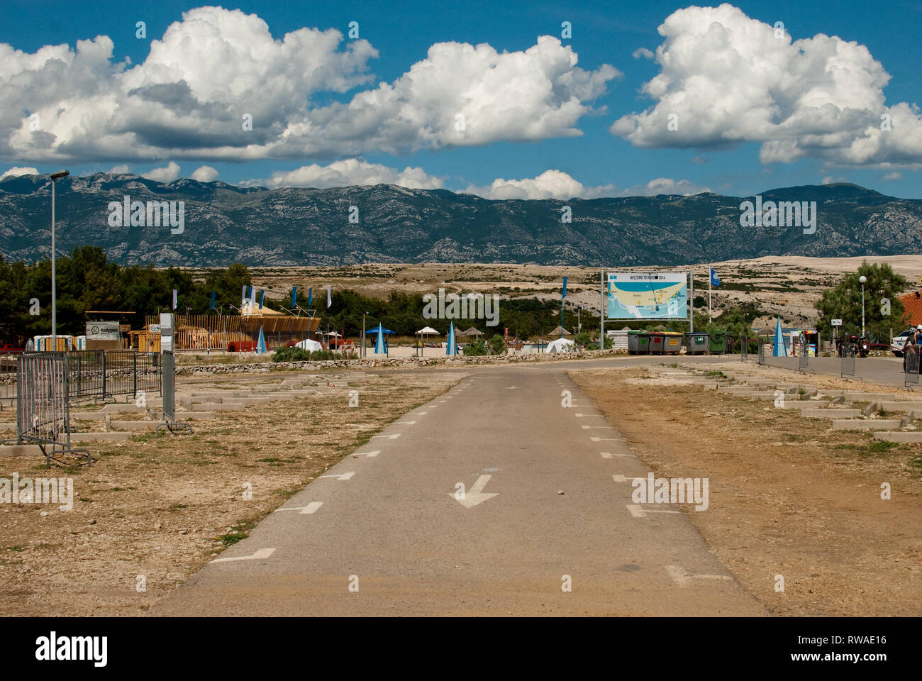 Landscape With Mountains And Road With Arrow On The Entrance To Zrce Beach During Hideout Festival Island Of Pag Croatia Stock Photo Alamy