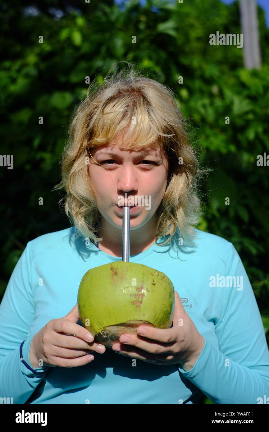 girl enjoying coconuts Stock Photo Alamy