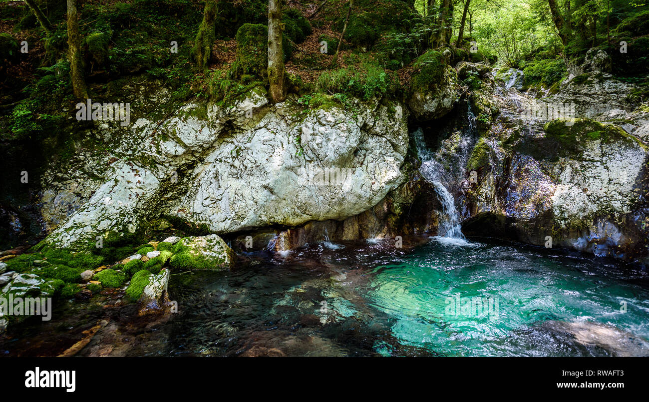 Idyllic mountain river in Lepena valley, Soca - Bovec Slovenia. Sunik water grove - beautiful mountain stream with waterfall and pools of green turquo Stock Photo